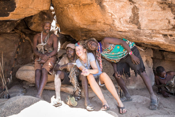 A tourist with the Hadzabe tribesmen in Tanzania